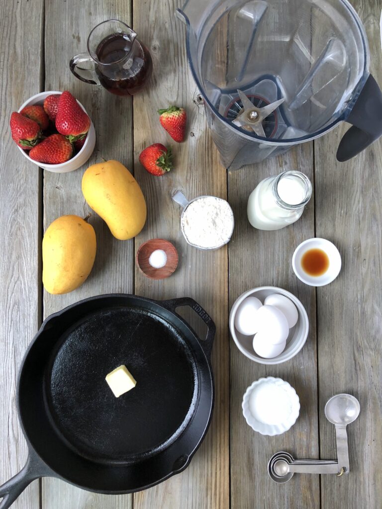 Flour, eggs, sugar, butter, strawberries, and mango ingredients