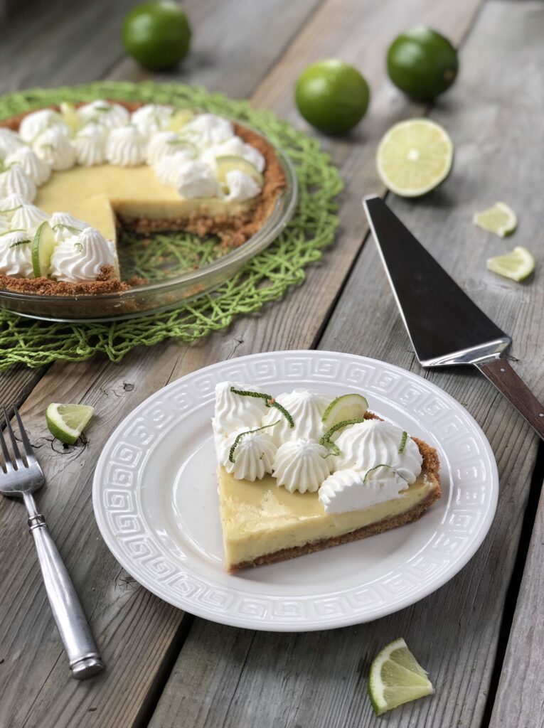 Slice on key lime pie on plate