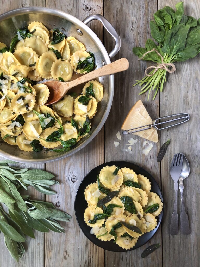 Pasta in skillet with a bowl on the side