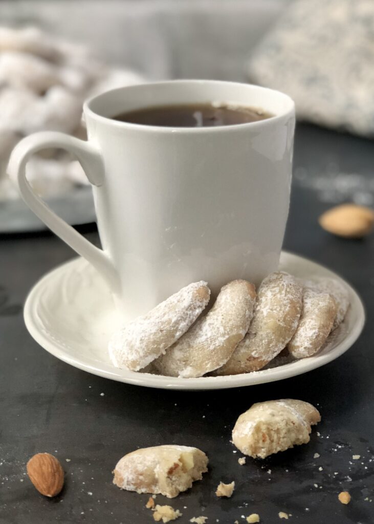 Mug of tea with four cookies