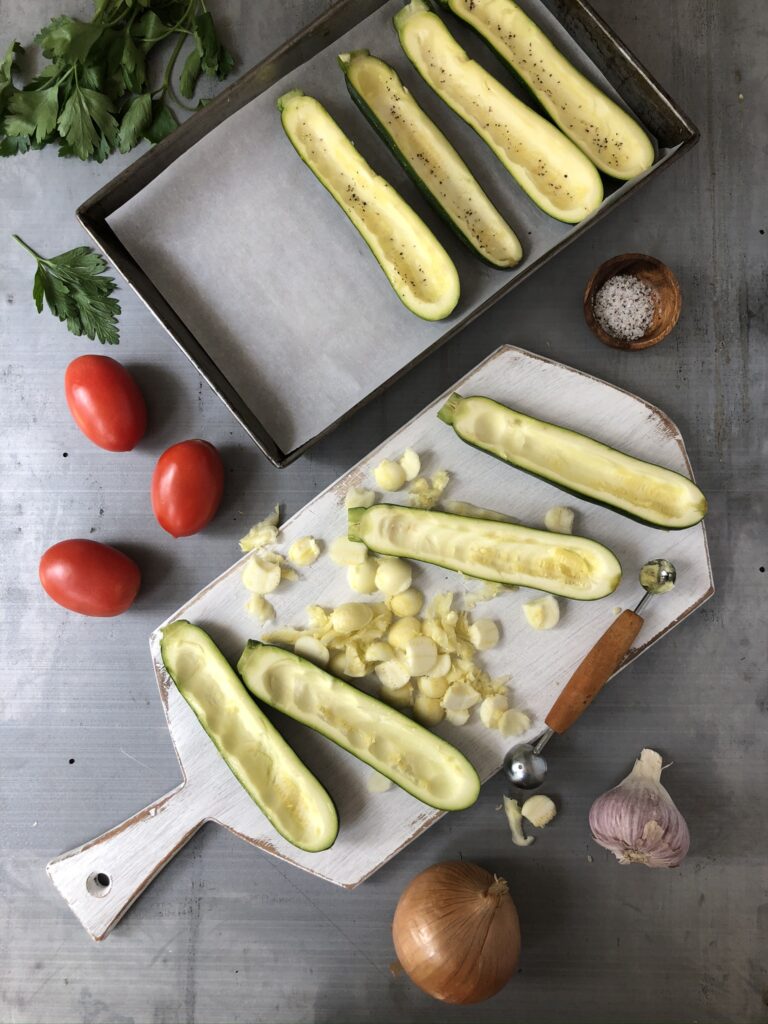 Zucchini halved on a cutting board